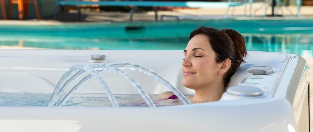 woman relaxing ion hot tub with water fountain