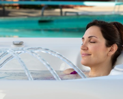 woman relaxing ion hot tub with water fountain
